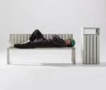 Urbantime Liberty.080 outdoor bench and litter bin in a studio setting with relaxed seating interaction.
