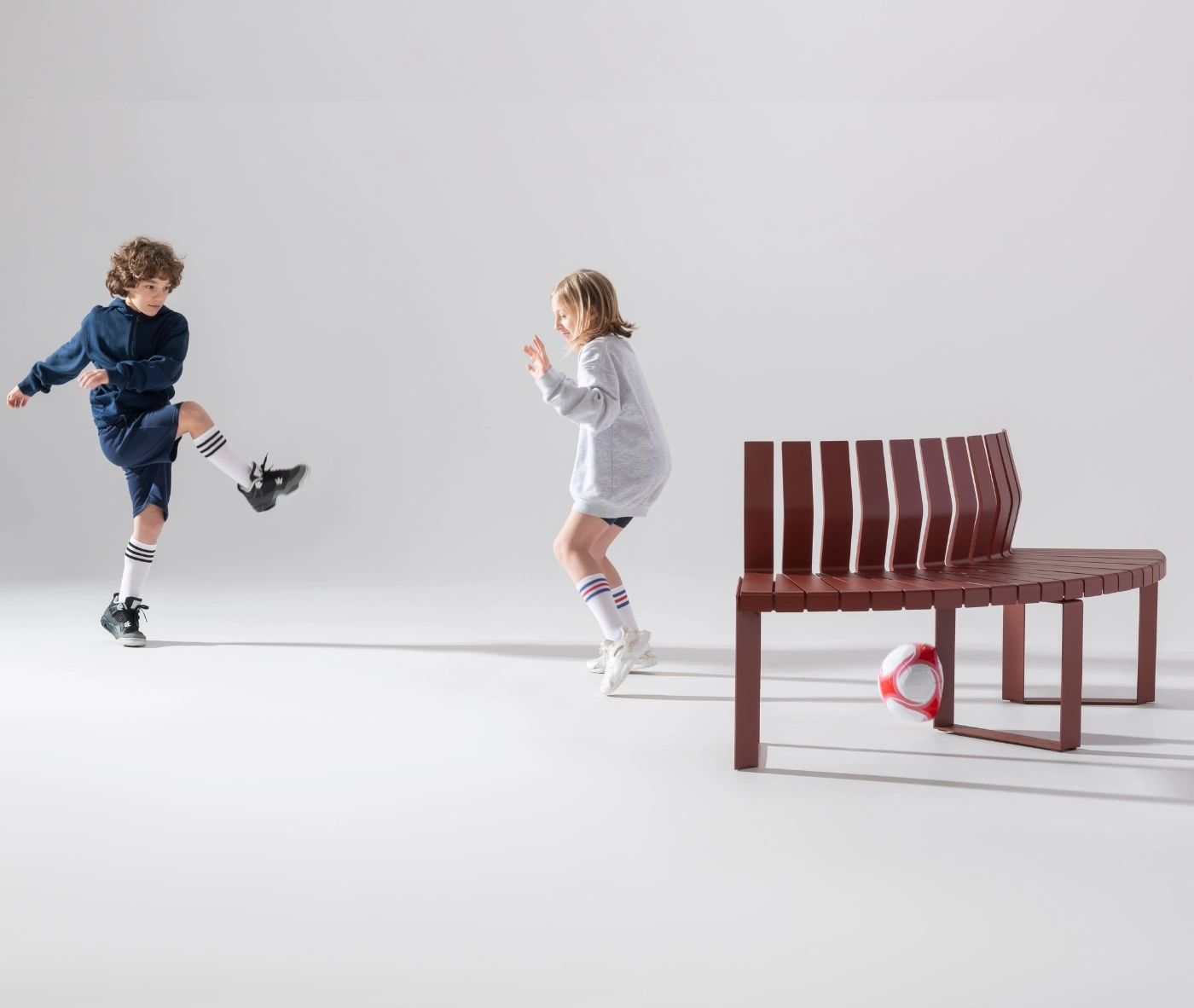 Urbantime Liberty.080 outdoor seating featured in a studio scene with casual sports interaction.