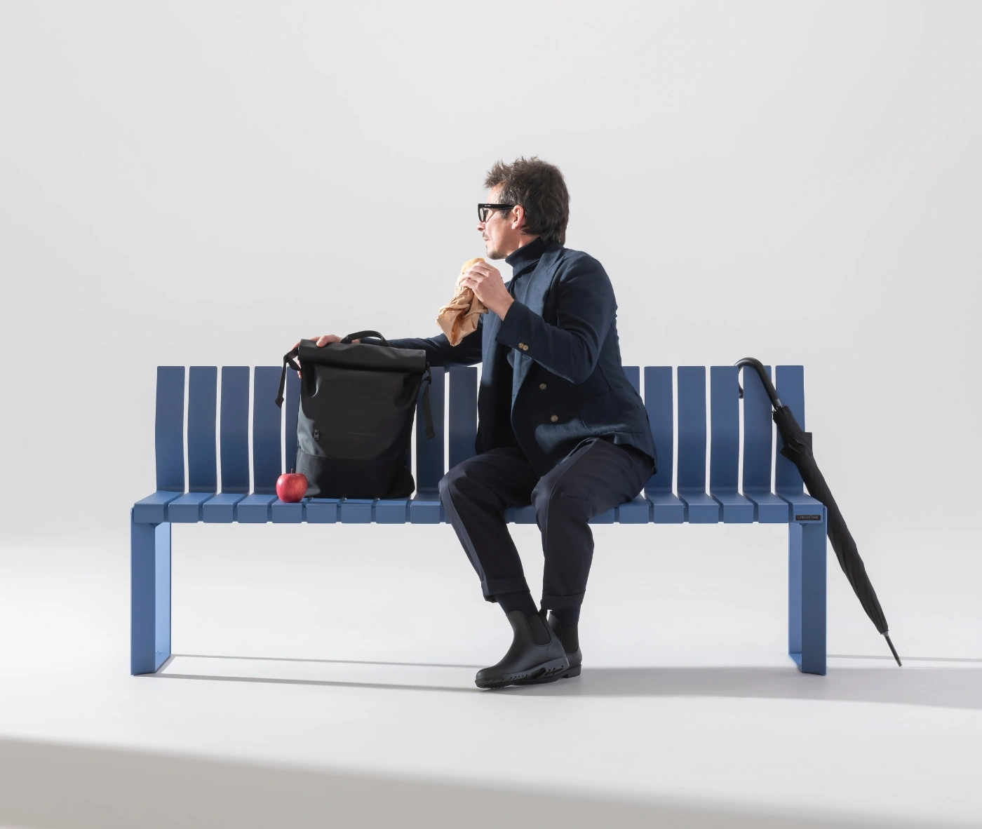 Urbantime Liberty.080 outdoor bench in a studio setting with casual seating interaction.