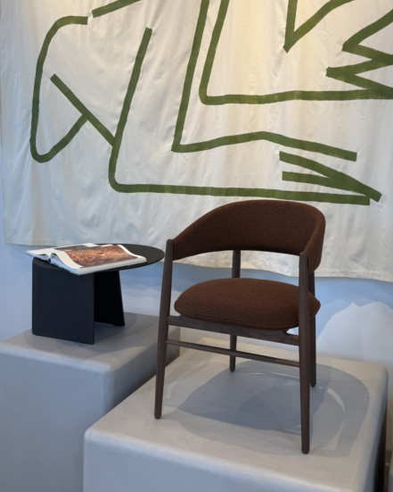 True Aura and Nomade table in a showroom setting.