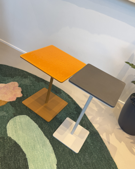 True Cremino tables in showroom setting with rectangular top and slim pedestal base.