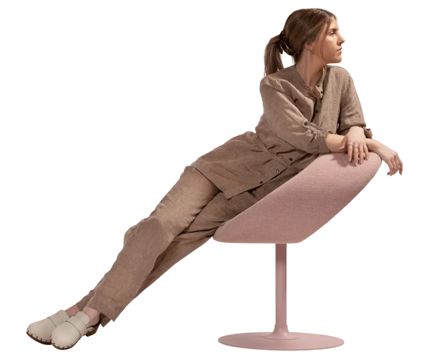 Person reclining on a Bla Station Innovation C-shaped chair that combines seating and a tabletop surface.
