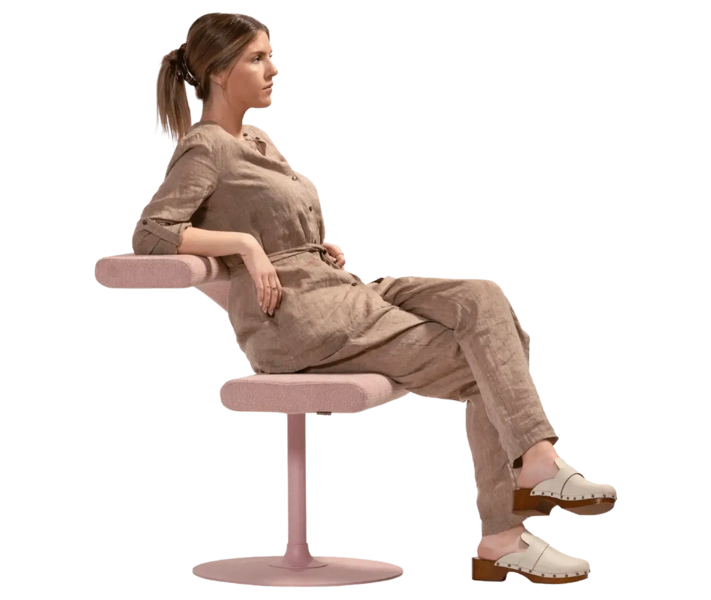 Person seating on Bla Station Innovation C-shaped chair, combining it's seat and tabletop.