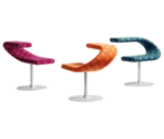Bla Station Innovation C-shaped chairs with metal pedestal bases in assorted patterned upholstery options.