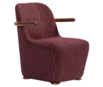 Bla Station Jackson lounge chair in front-right view, upholstered in patterned burgundy fabric with a curved backrest and armrests.