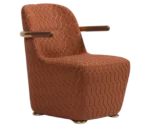 Bla Station Jackson lounge chair in front-right view, upholstered in patterned fabric with a curved backrest and armrests.
