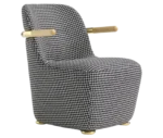 Bla Station Jackson lounge chair in front-right view, upholstered in patterned fabric with a curved backrest and timber armrests.