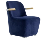 Bla Station Jackson lounge chair in front-right view in blue corduroy upholstery with curved backrest and timber armrests.