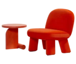 Bla Station Liv table and Max lounge chair, front-left view in red upholstery with rounded backrest, thick cushioned seat and upholstered legs.