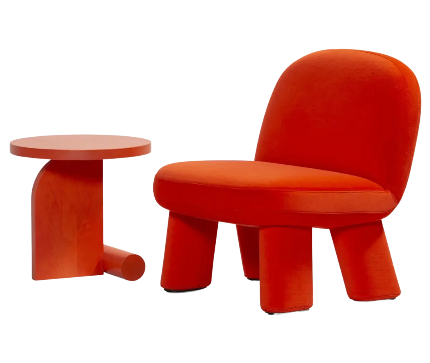 Bla Station Liv table and Max lounge chair, front-left view in red upholstery with rounded backrest, thick cushioned seat and upholstered legs.