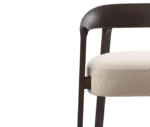 Close-up, half front view of the Cizeta Aurea armchair with solid ash frame and upholstered seat.