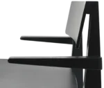 Close-up of the Cizeta Derby 2602 chair with black timber armrests and frame.