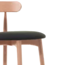 Detail view shown in half right-side view, light timber frame and round upholstered seat.