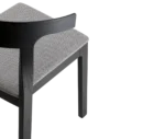 Close-up of Cizeta Torso chair shown in half rear view, black timber frame and grey upholstered seat.