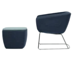 True Arca lounge chair, left-side view with a dark blue fully upholstered wraparound shell and metal sled base.