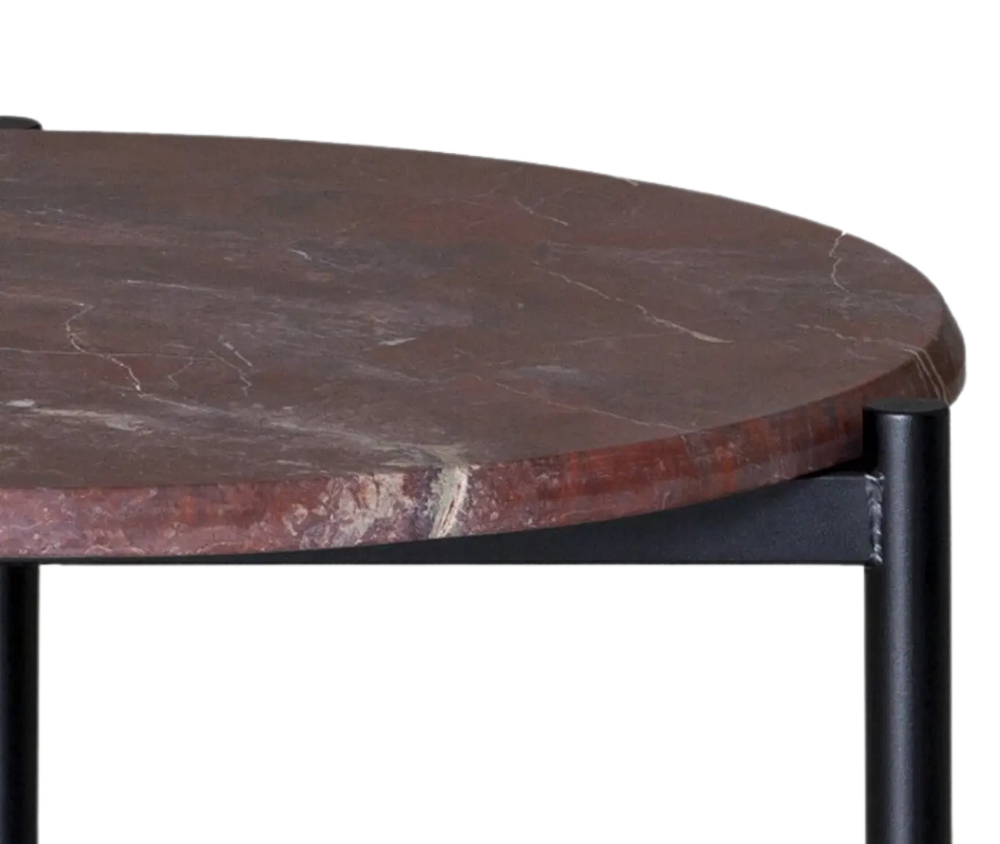 Half close-up view True Blade coffee table with a rounded red marble top and slim metal legs.