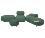 True Code modular seating with green upholstery, soft rounded forms and an integrated side table.