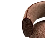 Half close-up view True Code lounge chair with textured rust upholstery, a rounded seat and curved patterned backrest.