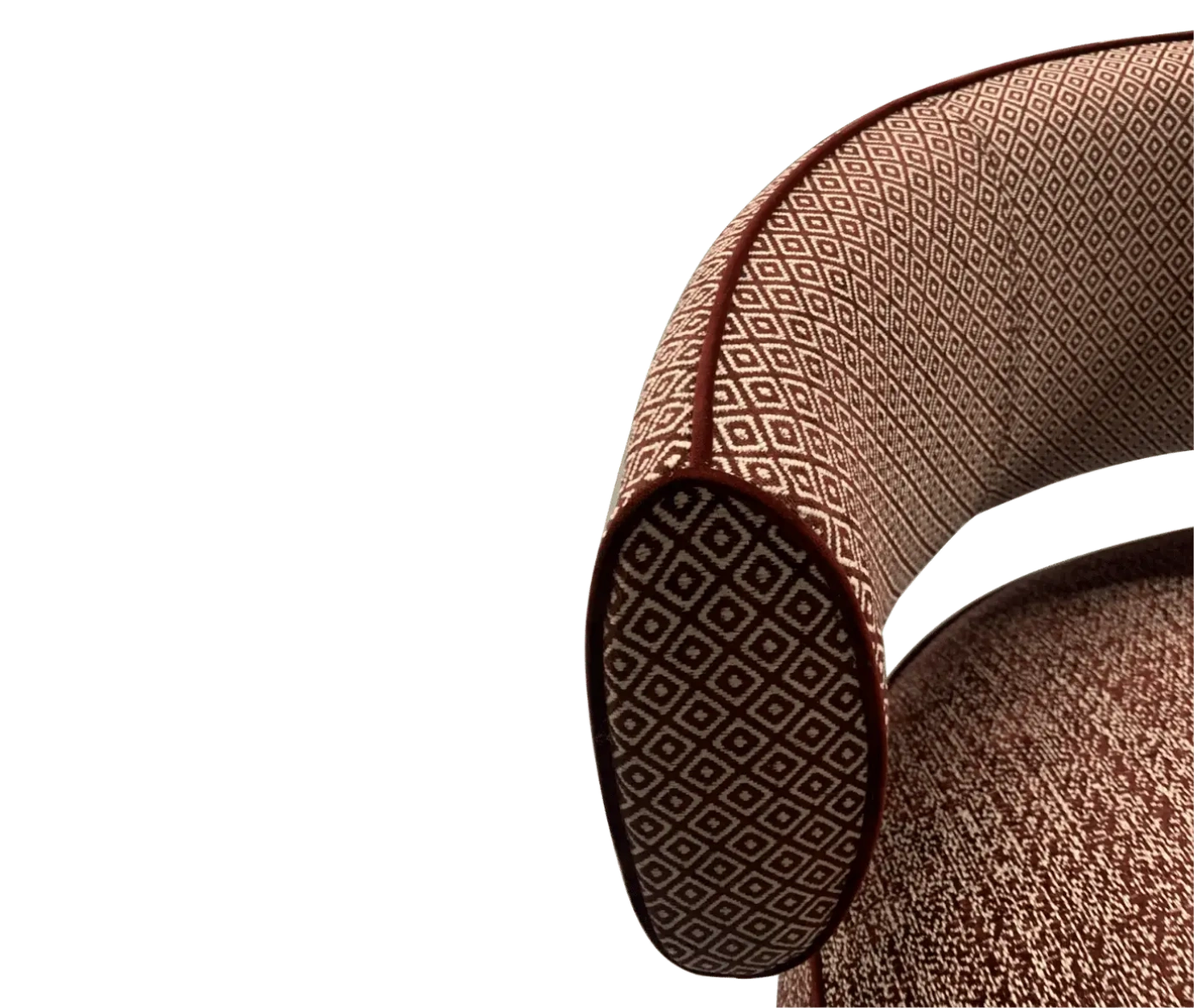 Half close-up view True Code lounge chair with textured rust upholstery, a rounded seat and curved patterned backrest.
