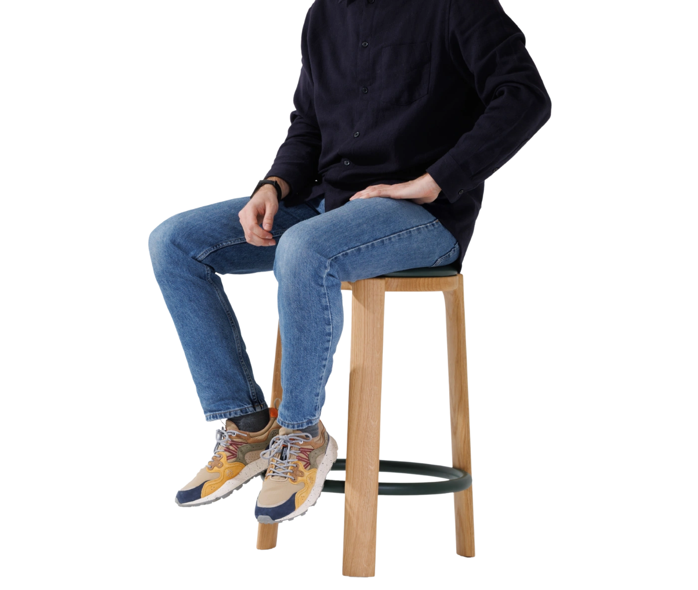 True Cute stool shown in use with a person seated.