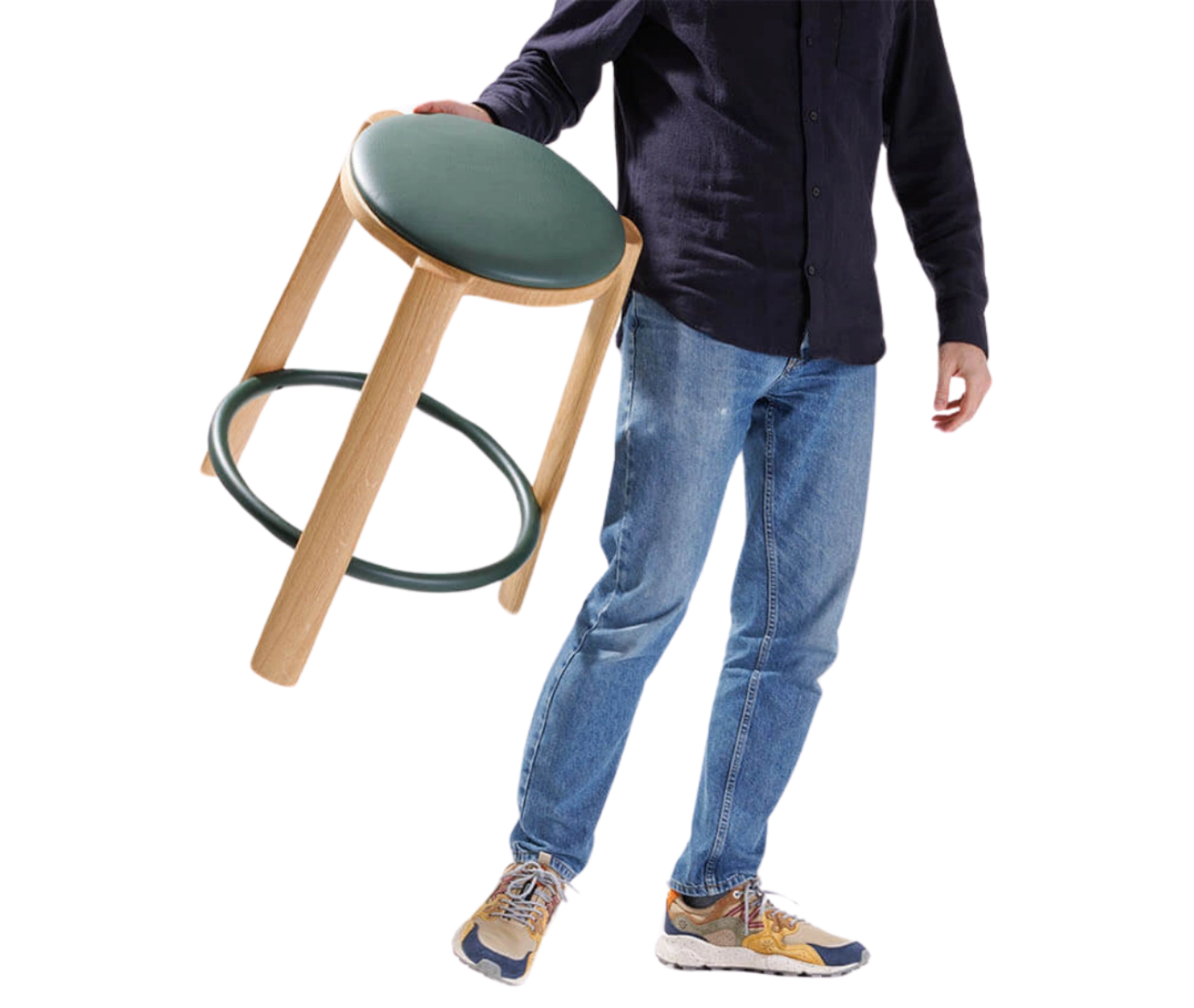 True Cute stool shown carried by a person, with its timber frame and circular footrest.