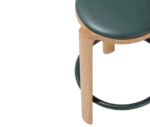 Close-up of True Cute stools in dark upholstered seats, timber legs, and circular footrests.