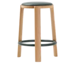 True Cute stool with a dark leather upholstered seat, timber legs and a circular footrest.