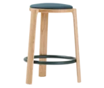 True Cute stool with a dark upholstered seat, timber legs and a circular footrest.