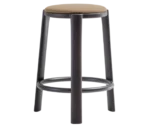 True Cute stool with a brown upholstered seat, dark timber legs and a circular footrest.