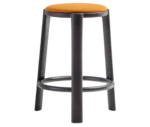 True Cute stool with orange upholstered seat, dark timber legs and a circular footrest.