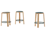 True Cute stools with upholstered seats, timber legs and circular footrests.