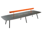 True Wing table in front-right view with dark timber top and frame, featuring an integrated brass reading lamp in orange finish.