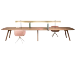 True Wing Library table in front view with long timber tabletop, timber legs and integrated brass reading lamp.