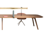Half view of True Wing Library table with dark timber tabletop, integrated brass reading lamp and workspace accessories.