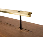 Detail view of the True Wing Library table with integrated brass reading lamp and dark timber tabletop.