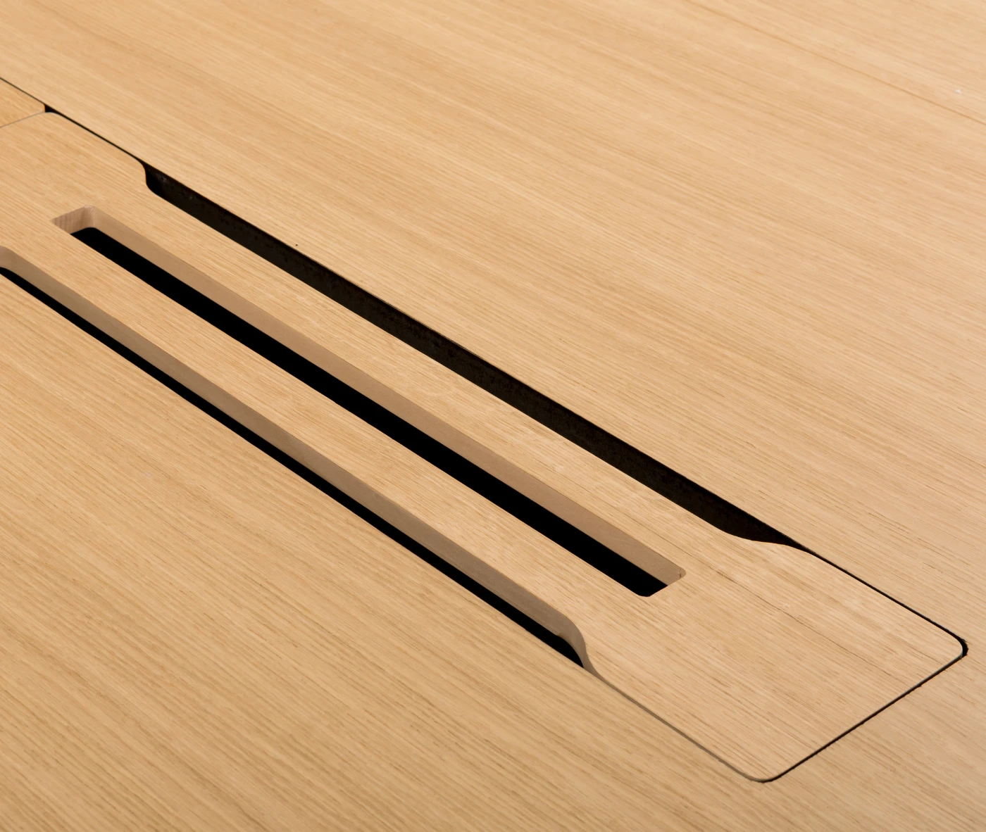 Close-up of the True Wing Meeting table magnetic wiring beam in light timber finish for cable management.